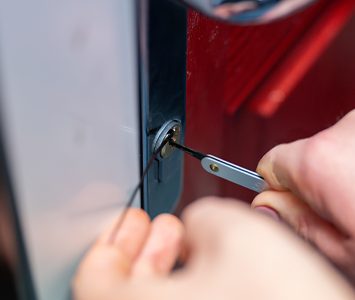 A local locksmith gaining entry to a locked out residents property by non-destructively picking the lock mechanism