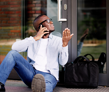 Man locked out of his business offices calling a local locksmith for emergency assistance