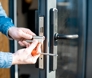 Aluminium door with replacement lock