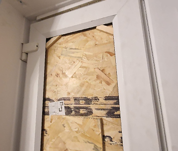 uPVC door boarded-up following a burglary