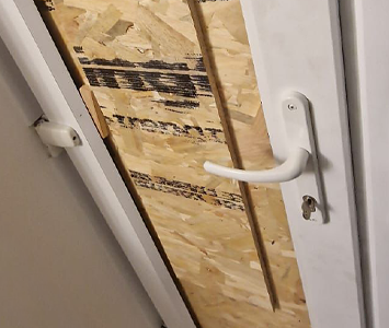 Boarded up door after a break-in