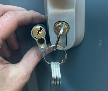 Locksmith replacing a damaged door lock